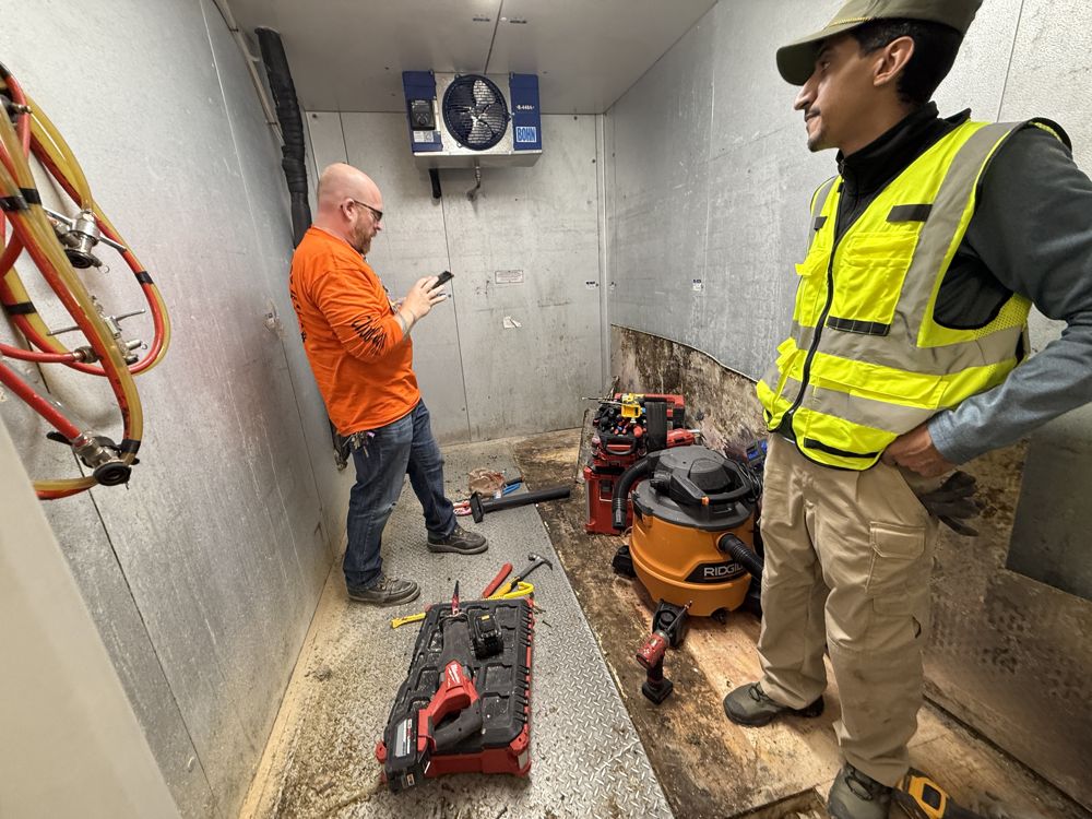 Technicians performing overhead structural work
